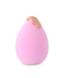 Pink makeup sponge with skin foundation isolated on white