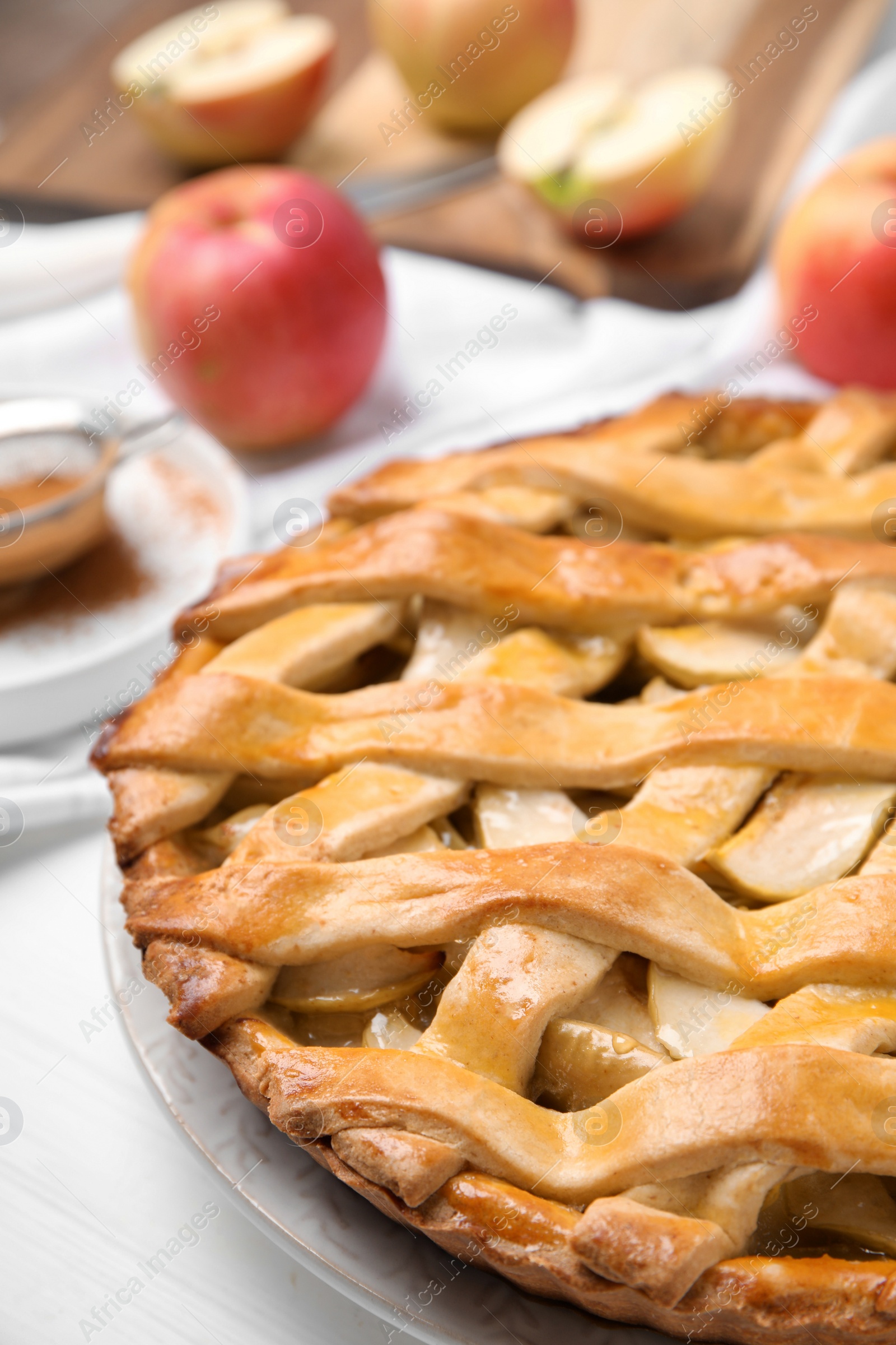 Photo of Delicious traditional apple pie on white table, closeup