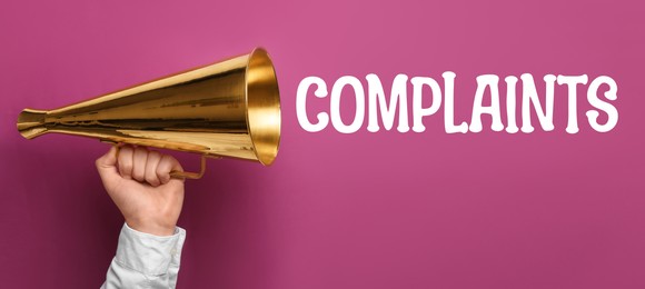 Image of Man holding retro megaphone on purple background, closeup. Word Complaints coming out from device. Banner design