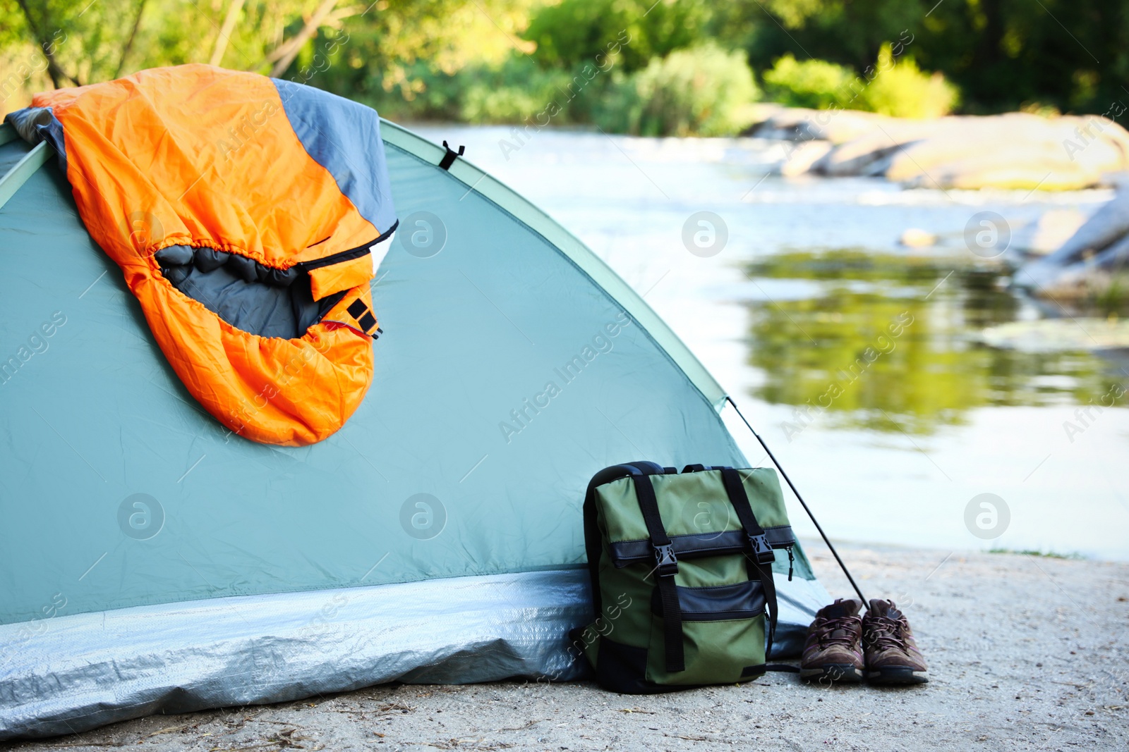 Photo of Sleeping bag and other camping gear outdoors