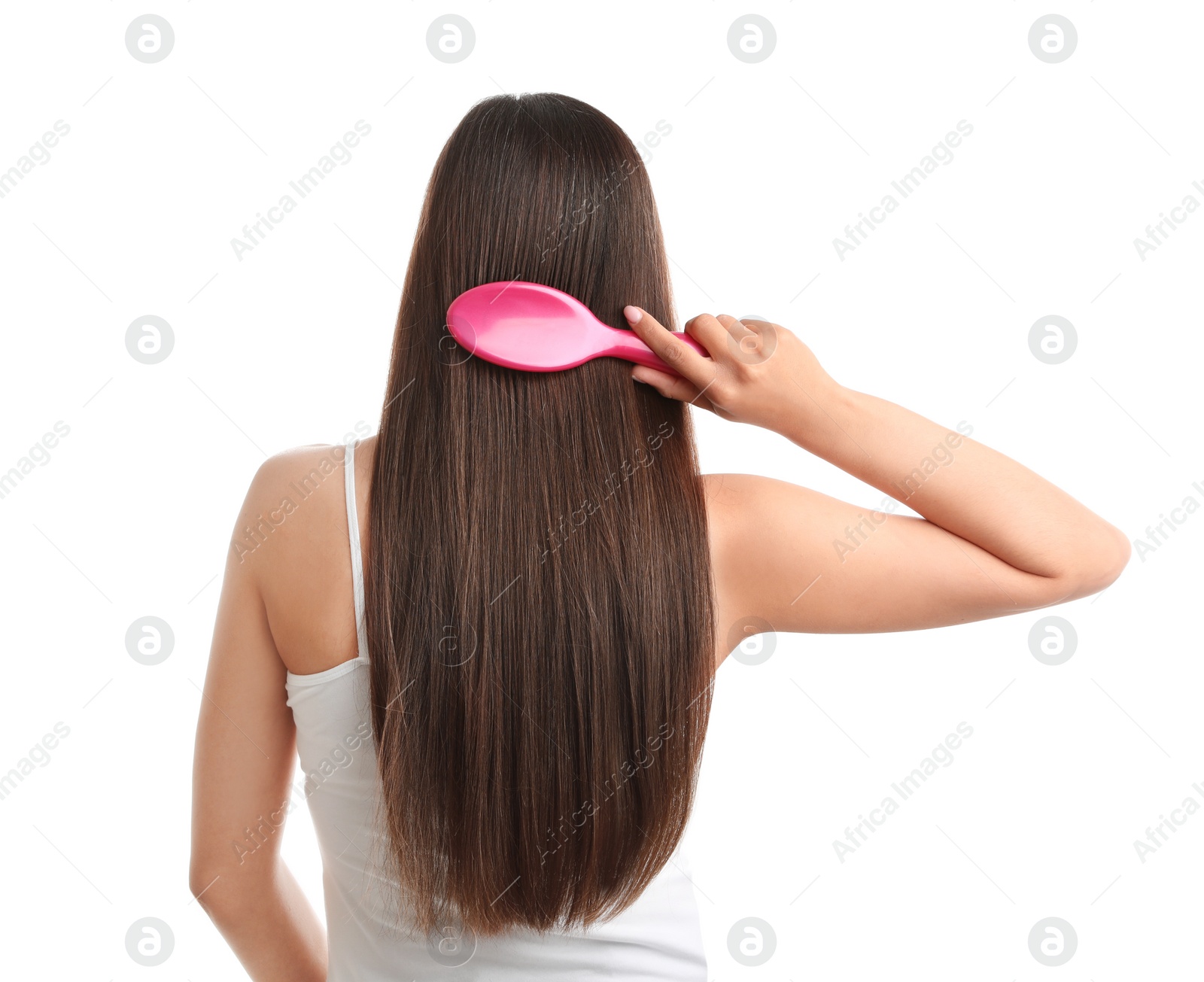 Photo of Back view of young woman with hair brush on white background