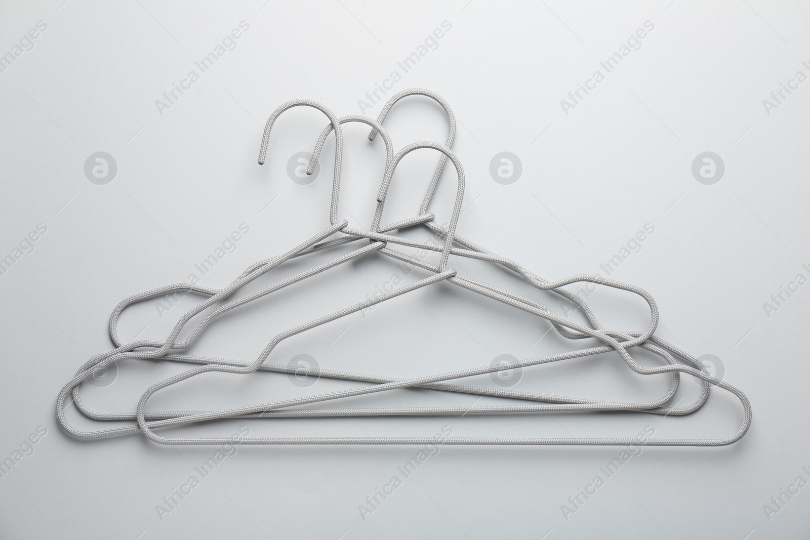 Photo of Hangers on light gray background, top view