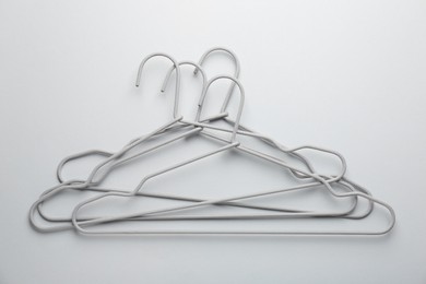 Hangers on light gray background, top view