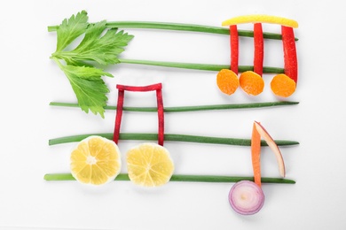 Photo of Musical notes made of vegetables and fruits on white background, top view