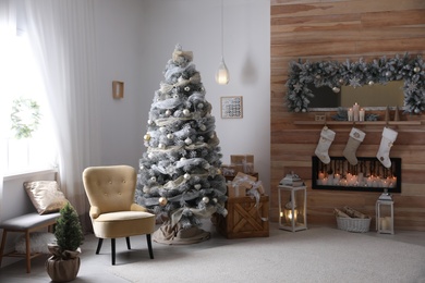 Festive interior with beautiful Christmas tree and gifts