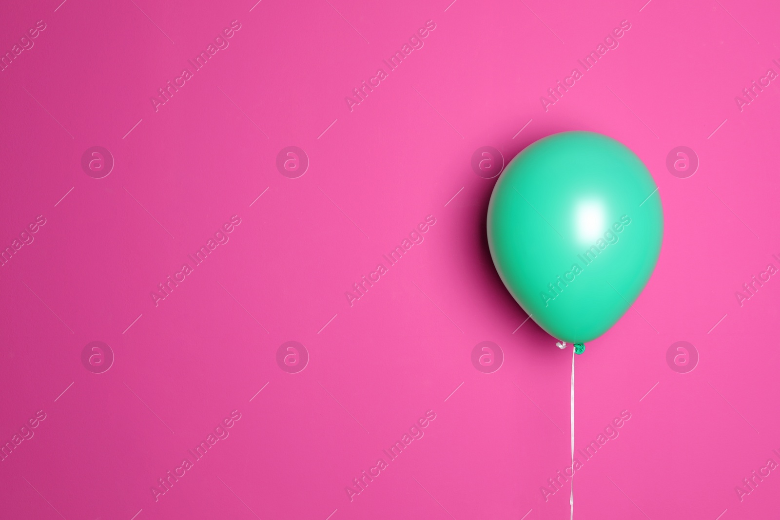 Photo of Green balloon on color background. Celebration time