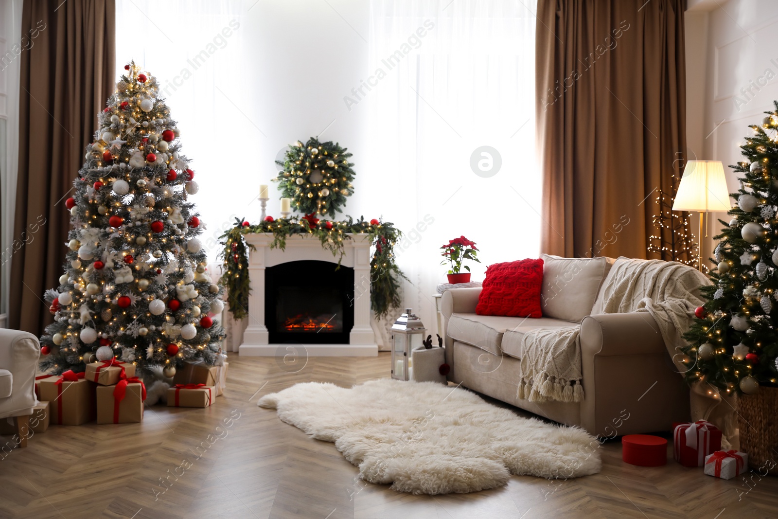 Photo of Festive living room interior with Christmas trees and fireplace