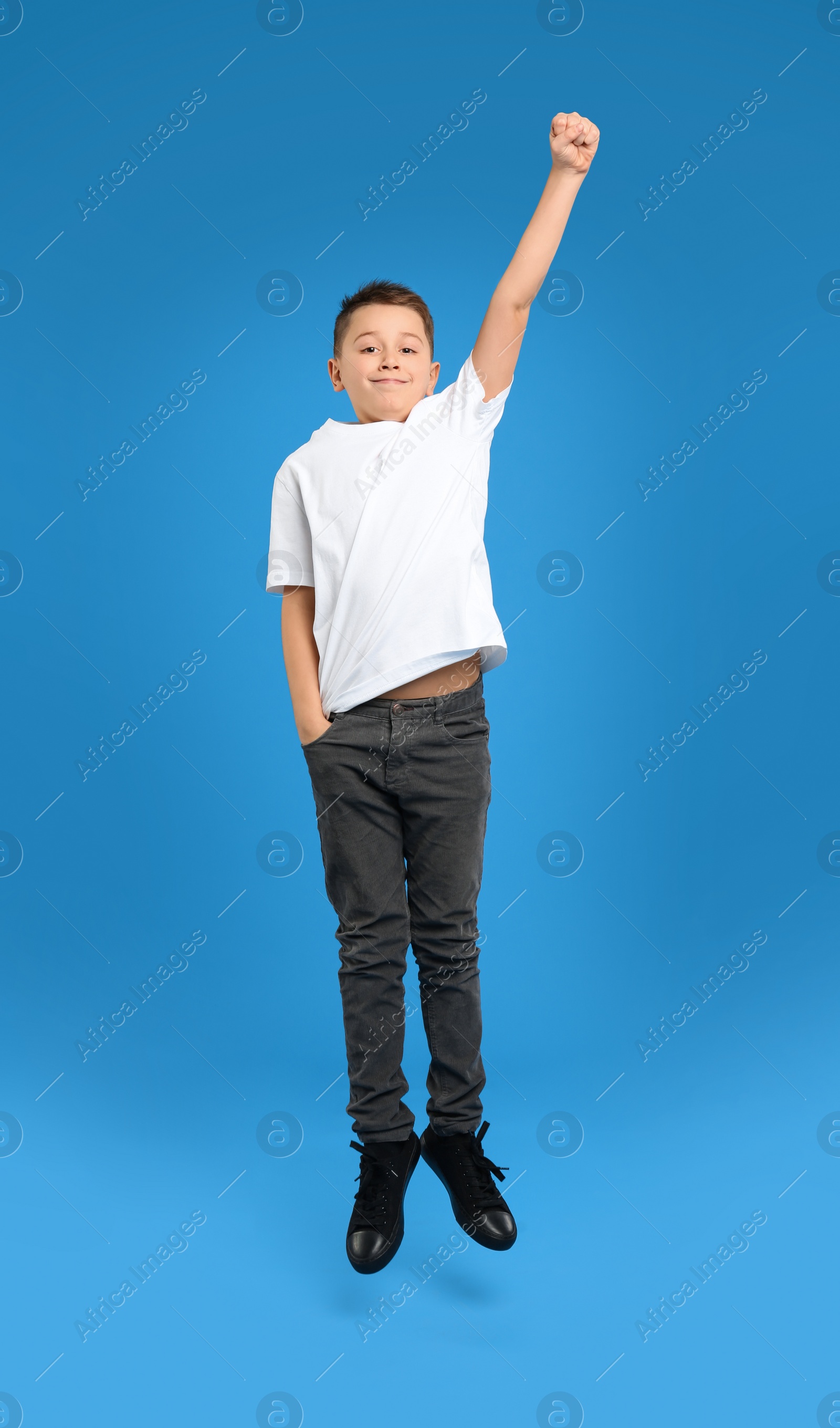Photo of Preteen boy jumping on light blue background