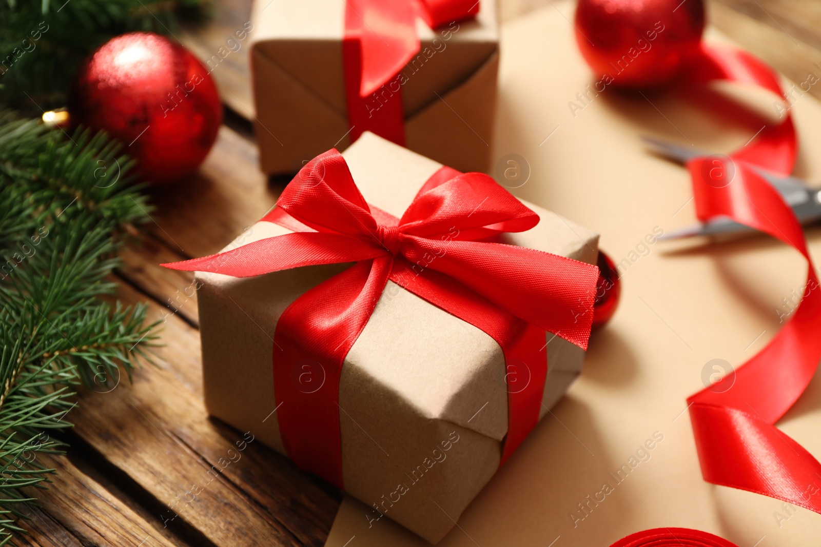 Photo of Christmas gift box and decor on wooden table, closeup