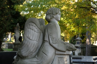 Photo of Beautiful statue of angel at cemetery. Religious symbol