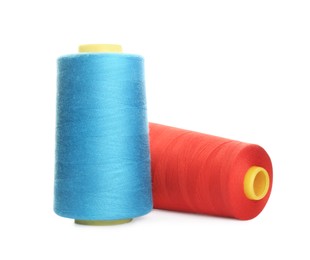 Photo of Different colorful sewing threads on white background