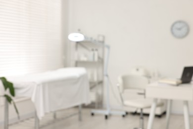 Photo of Blurred view of dermatologist's office with examination table