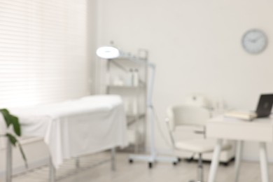 Blurred view of dermatologist's office with examination table