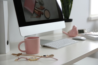 Photo of Comfortable workplace with computer on desk in home office, closeup