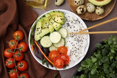 Delicious poke bowl and ingredients on textured table, flat lay