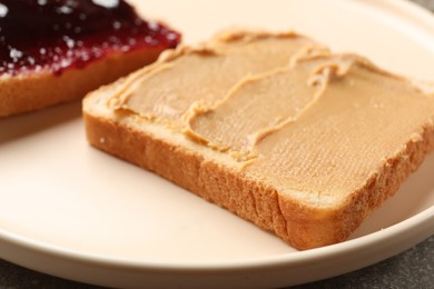 Photo of Tasty peanut butter sandwich on plate, closeup view