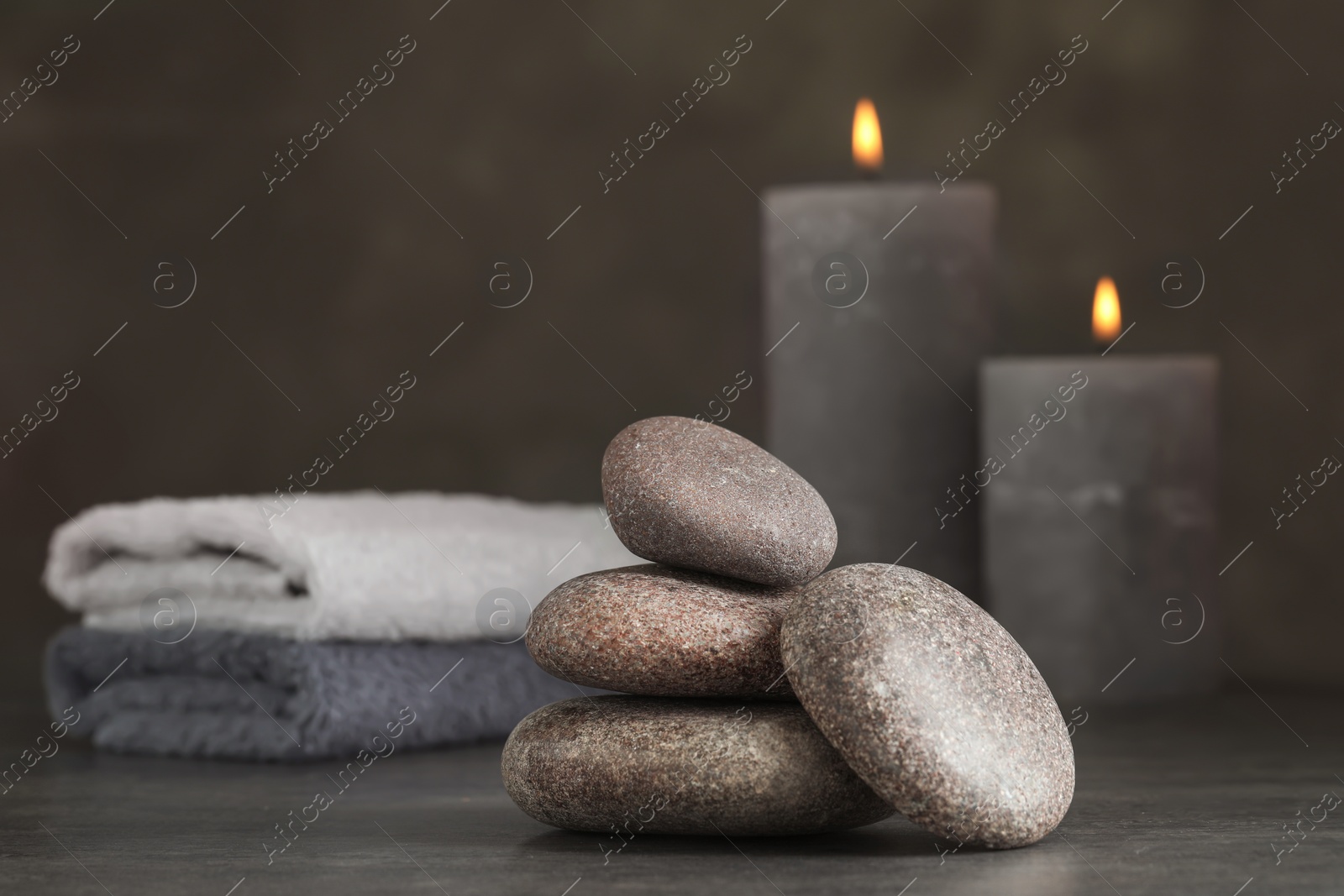 Photo of Stack of spa stones on grey table, closeup