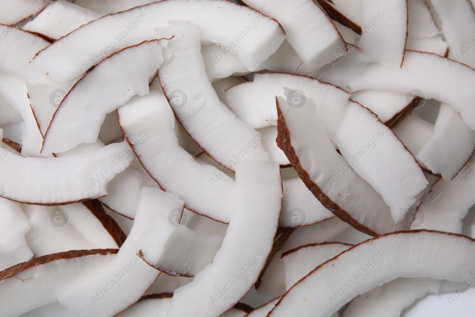 Photo of Fresh coconut pieces as background, top view