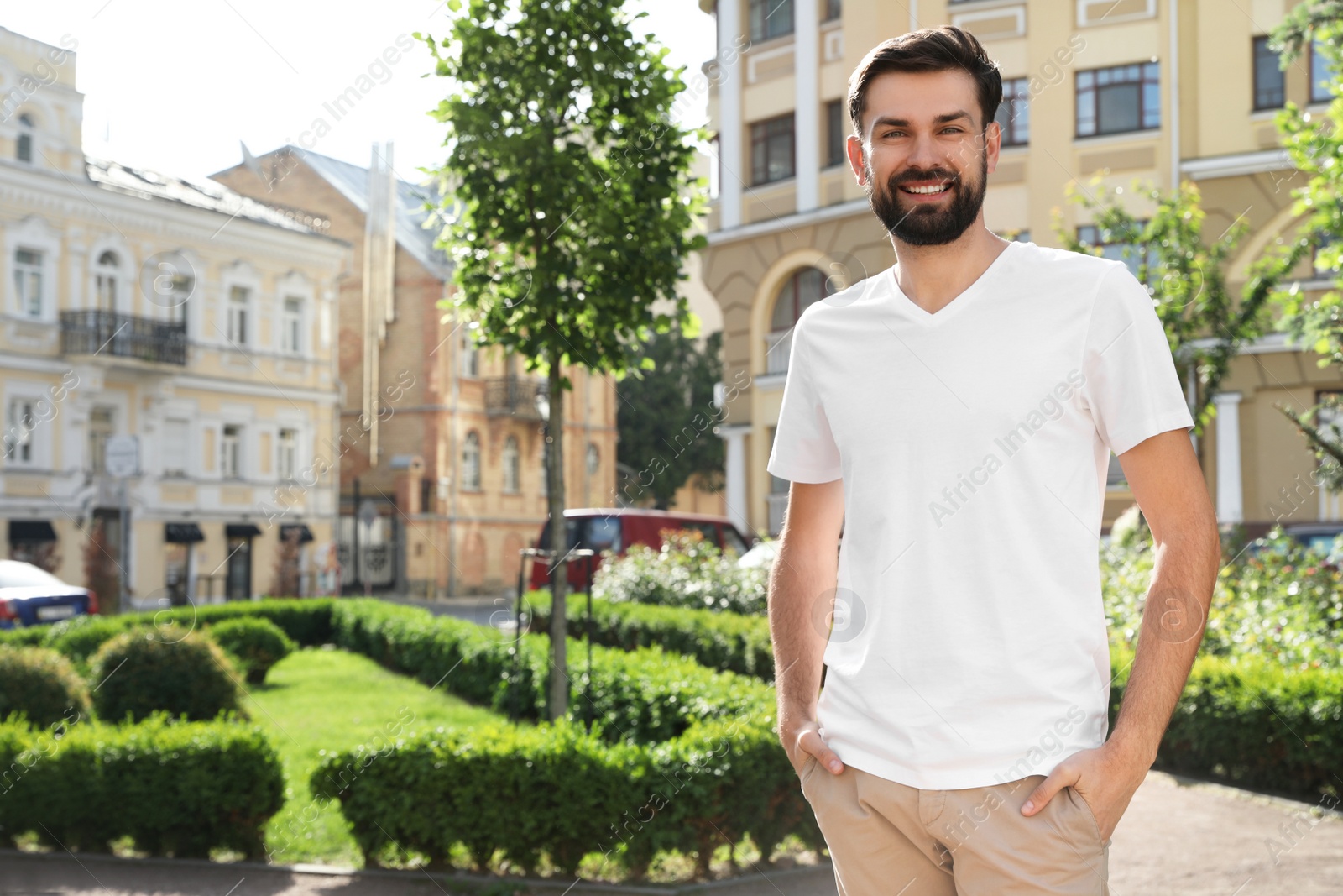 Photo of Handsome man in stylish outfit on city street