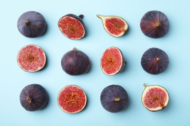 Photo of Fresh ripe purple figs on light blue background, flat lay