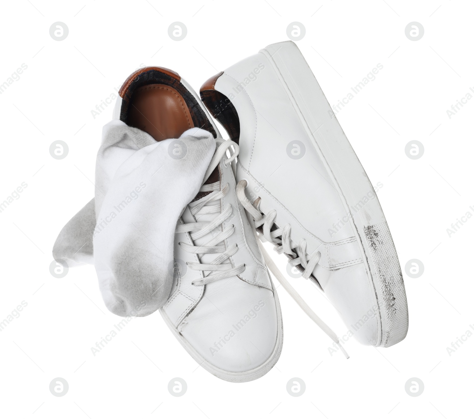 Photo of Dirty socks and sneakers on white background, top view