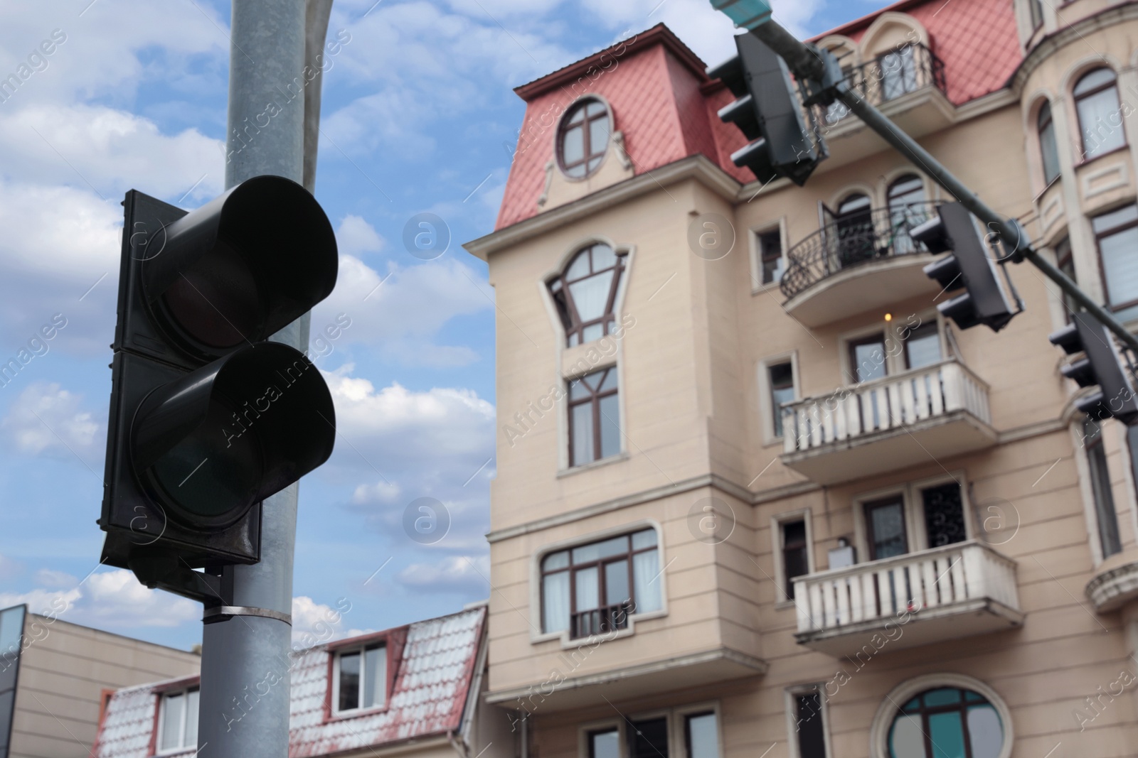 Photo of Modern traffic lights in city against cloudy sky