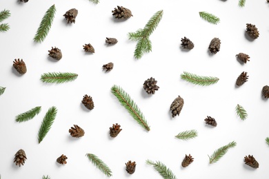 Flat lay composition with pinecones and fir branches on white background