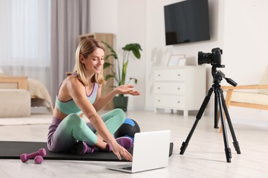 Photo of Fitness trainer recording online classes at home