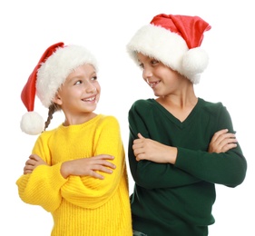 Photo of Happy little children in Santa hats on white background. Christmas celebration