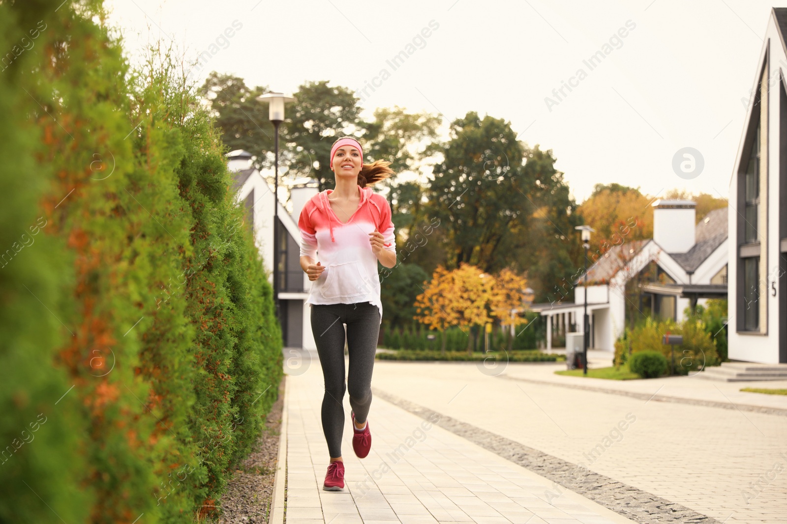 Photo of Beautiful sporty woman running on street. Healthy lifestyle