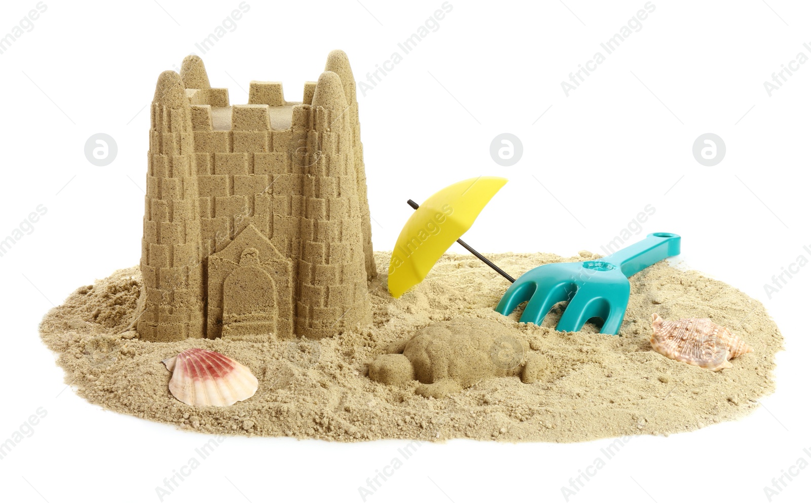 Photo of Pile of sand with beautiful castle, shells and plastic toys isolated on white