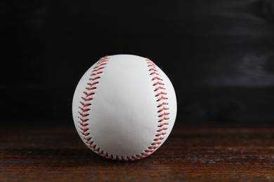 Photo of Baseball ball on wooden table, closeup. Sportive equipment