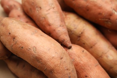 Whole ripe sweet potatoes as background, closeup