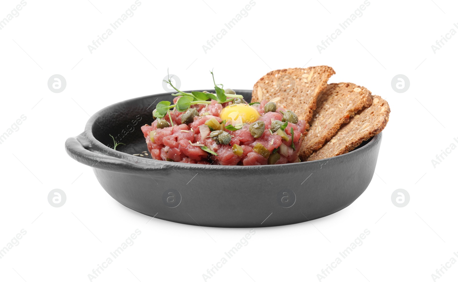 Photo of Tasty beef steak tartare served with yolk, capers and sliced bread isolated on white