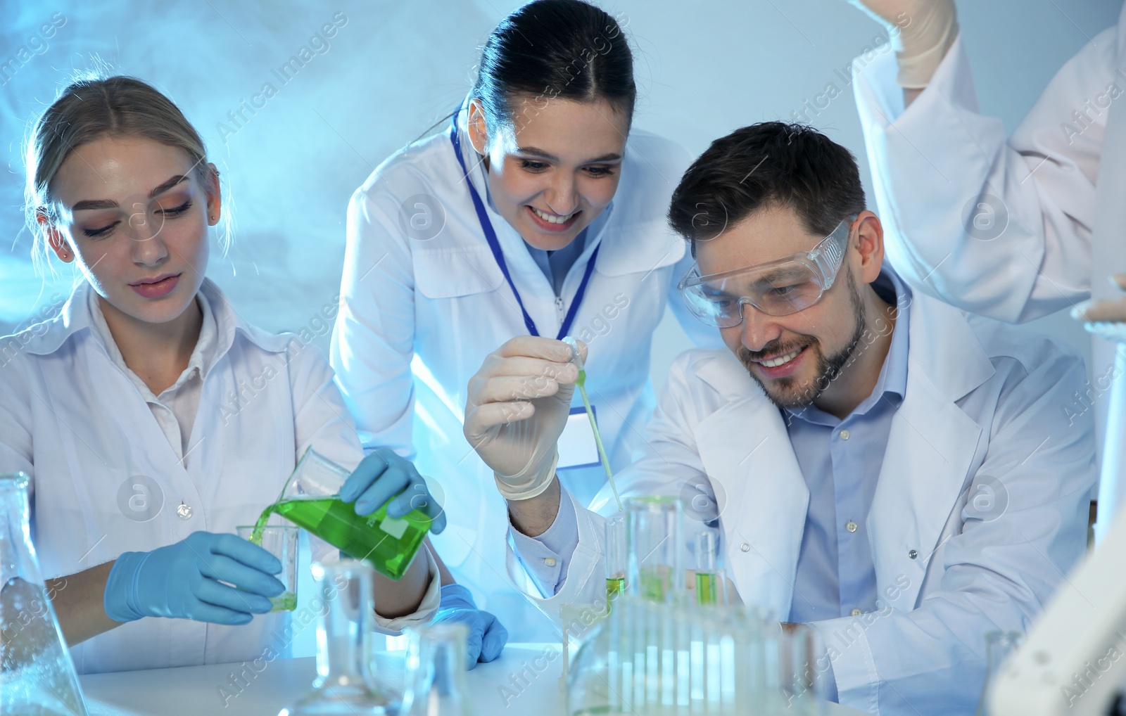 Photo of Group of scientists working in modern chemistry laboratory