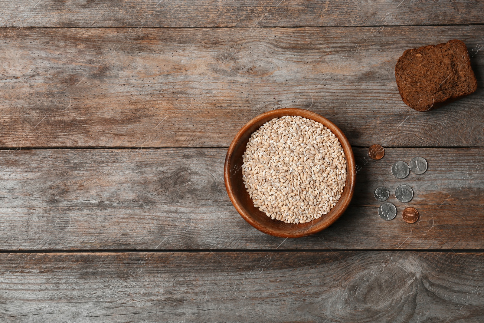 Photo of Flat lay composition with food, coins and space for text on wooden background. Poverty concept