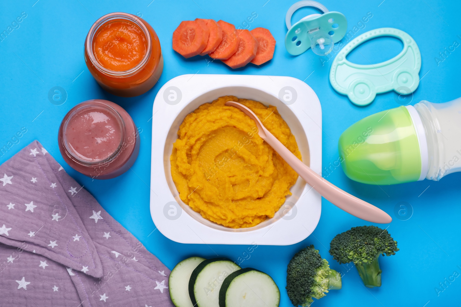 Photo of Flat lay composition with healthy baby food on light blue background