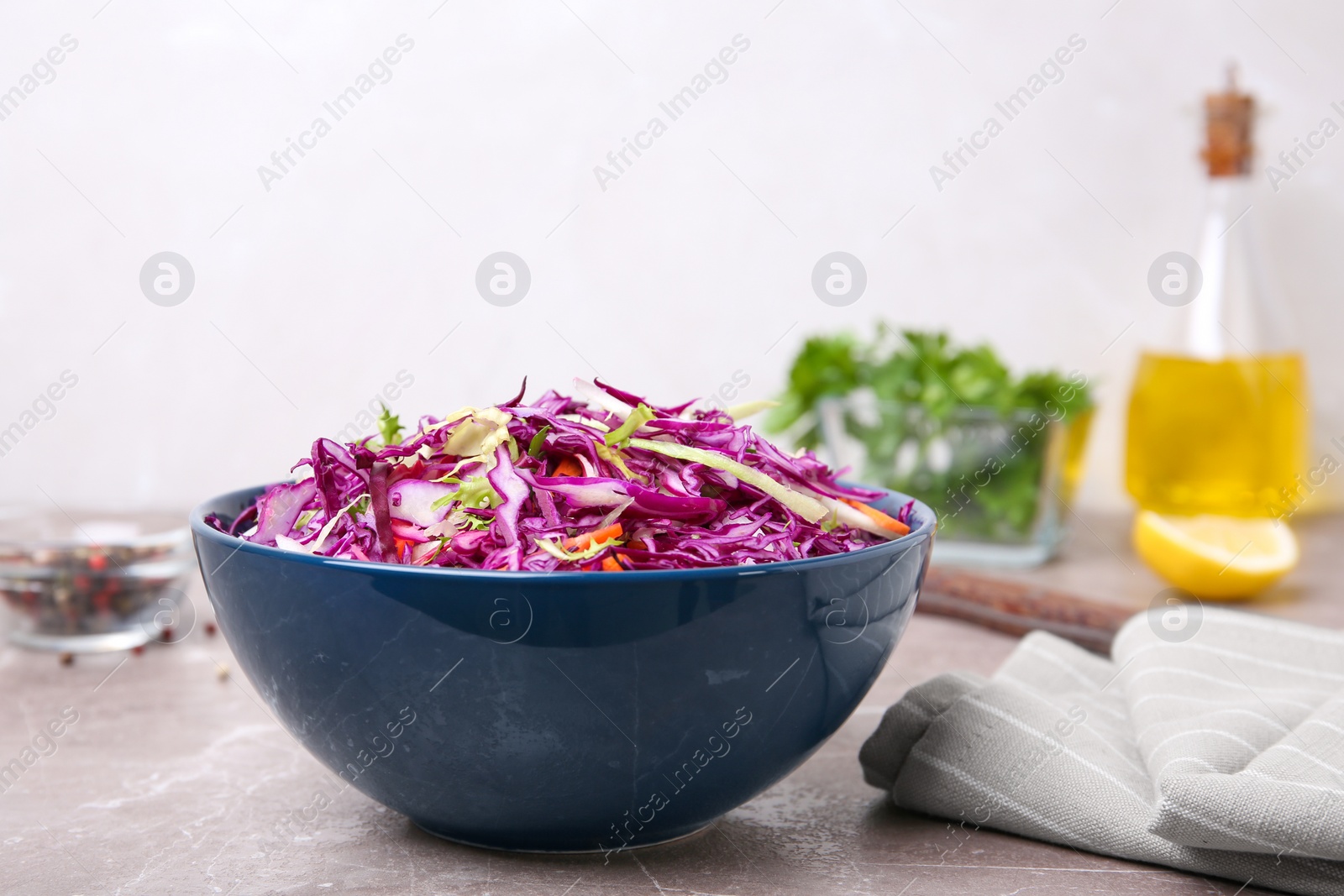 Photo of Bowl with chopped red cabbage on table