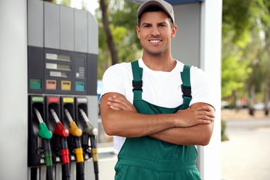Photo of Worker in uniform at modern gas station