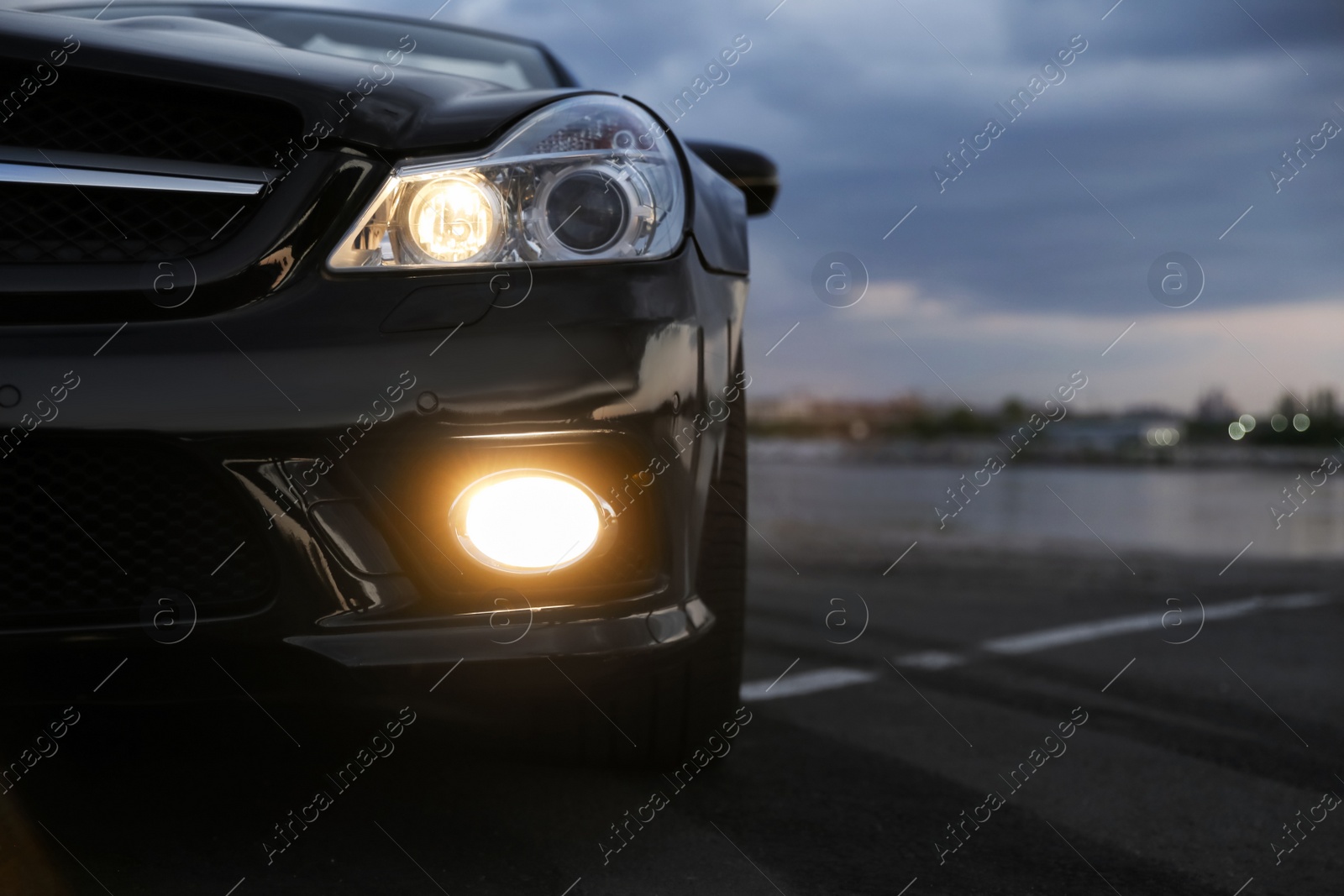 Photo of Luxury black convertible car outdoors in evening, closeup