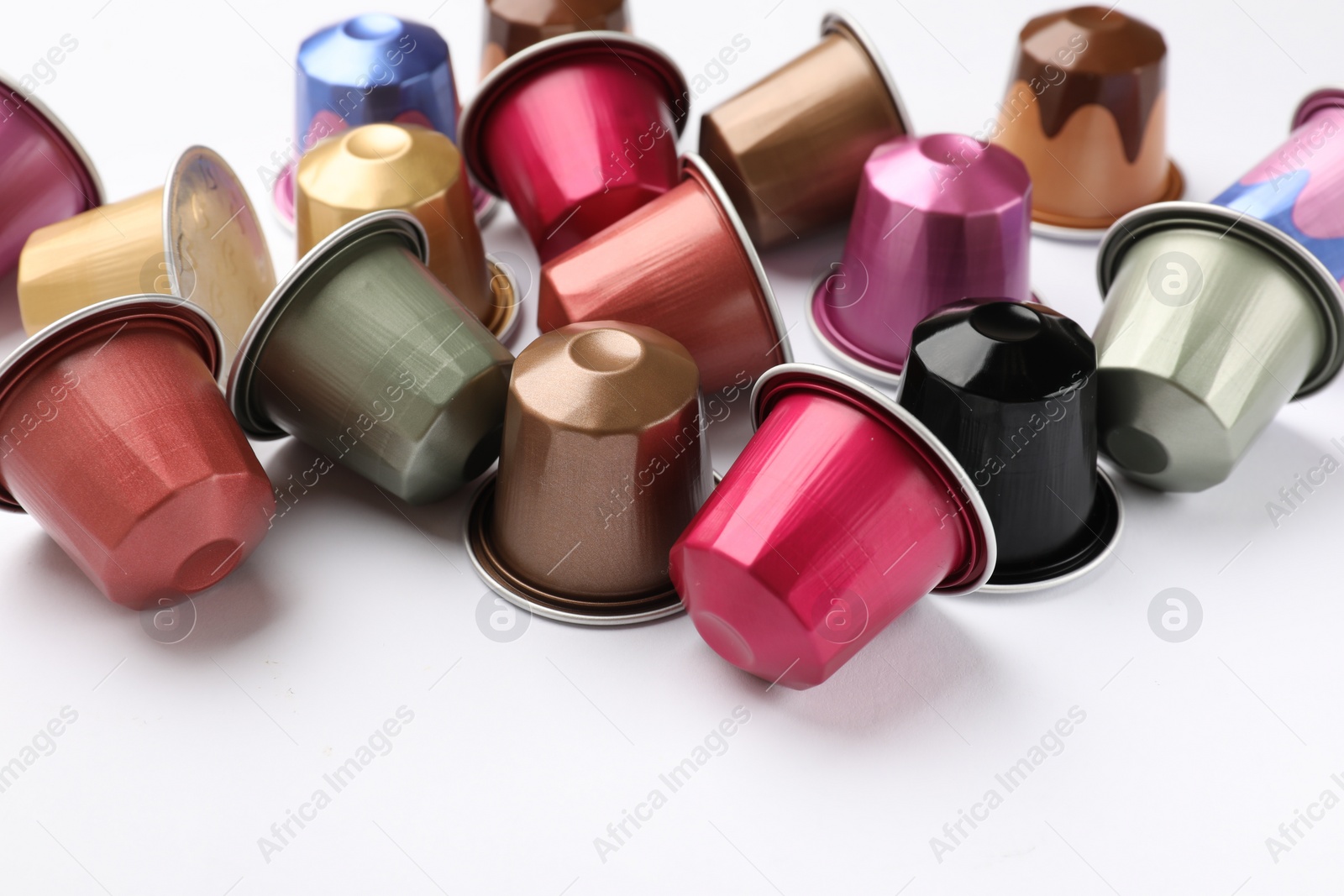 Photo of Many plastic coffee capsules isolated on white