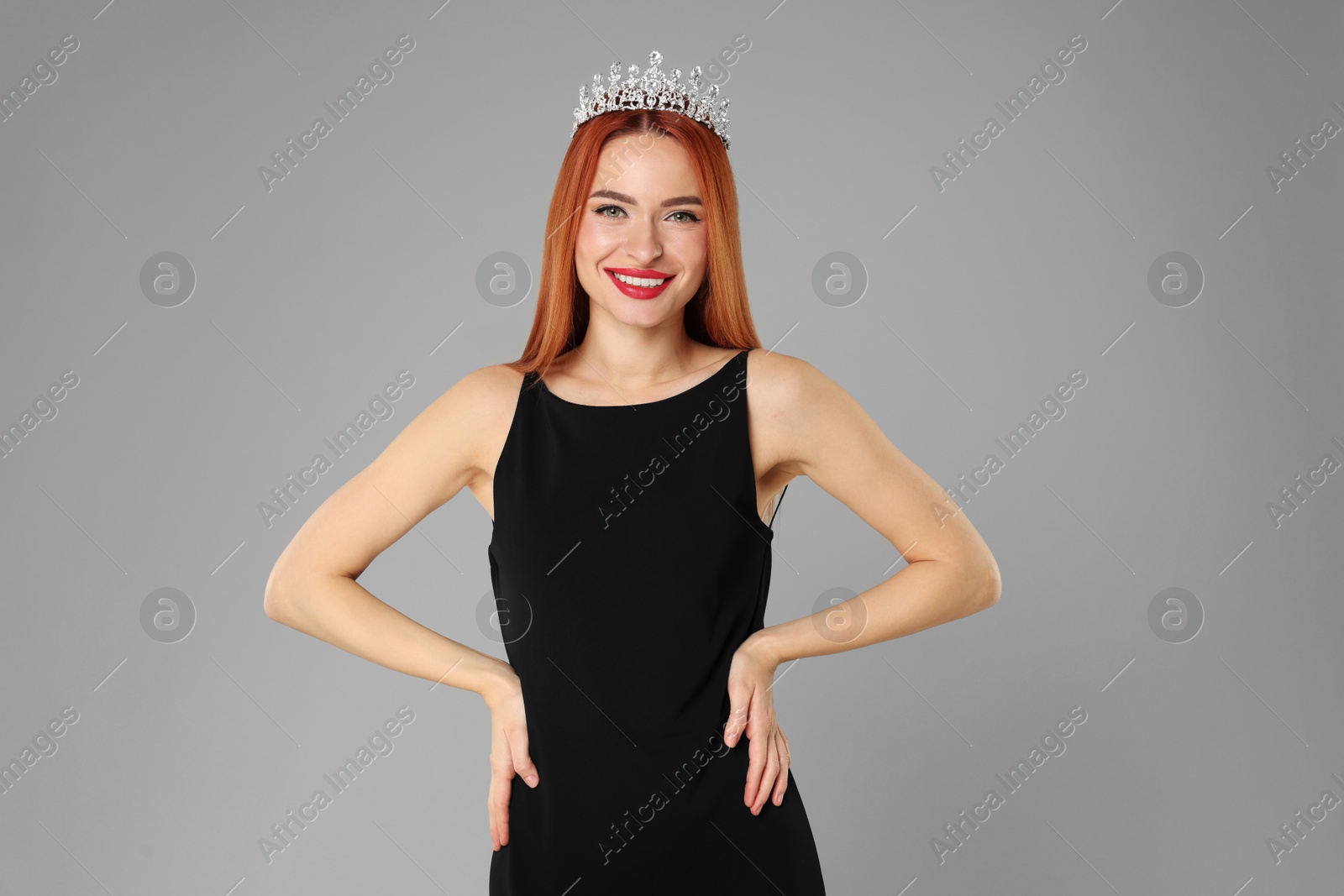 Photo of Beautiful young woman with tiara in dress on light grey background