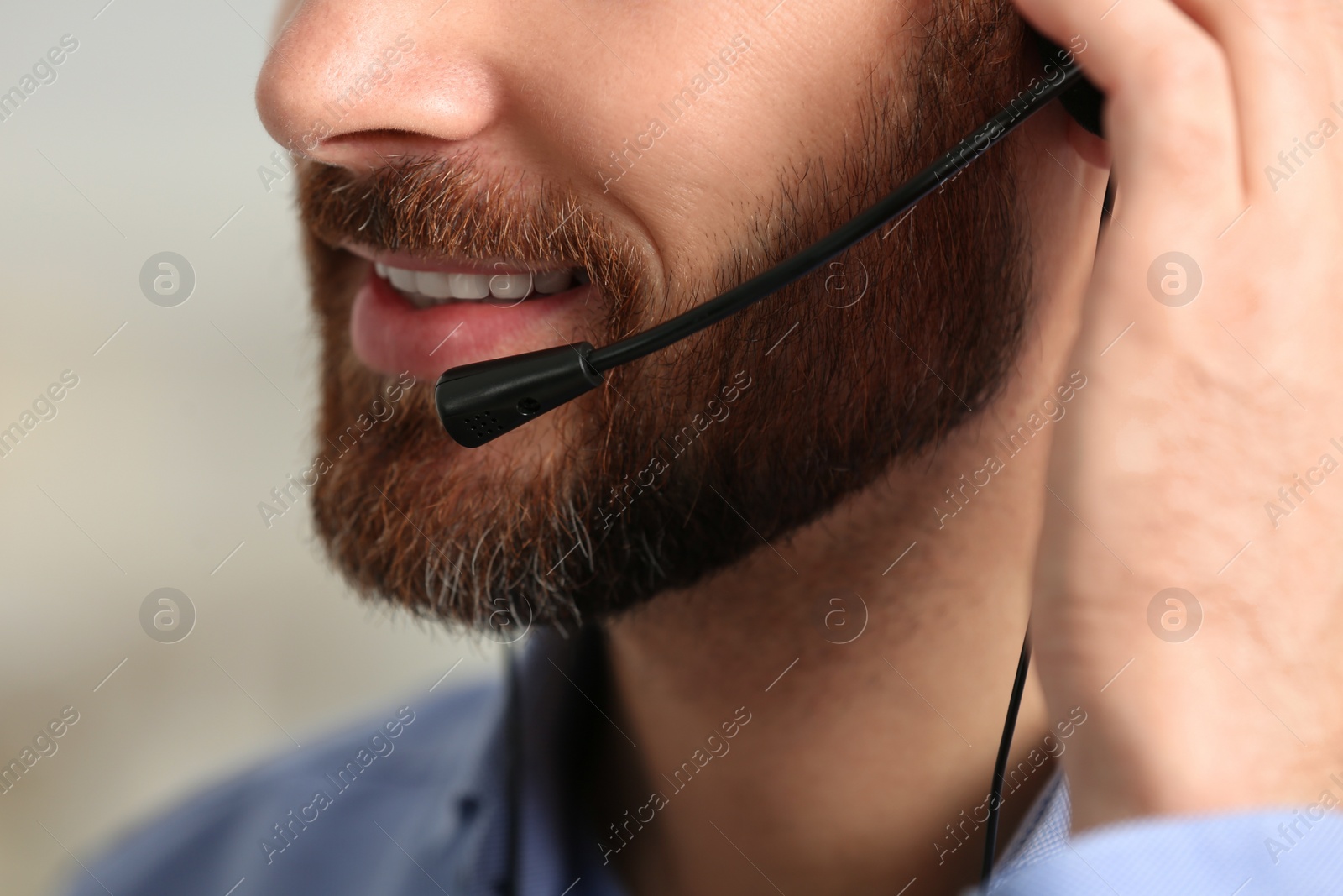 Photo of Hotline operator with headset working in office, closeup