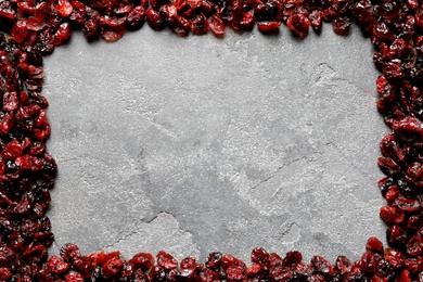 Photo of Frame of cranberries on color background, top view with space for text. Dried fruit as healthy snack