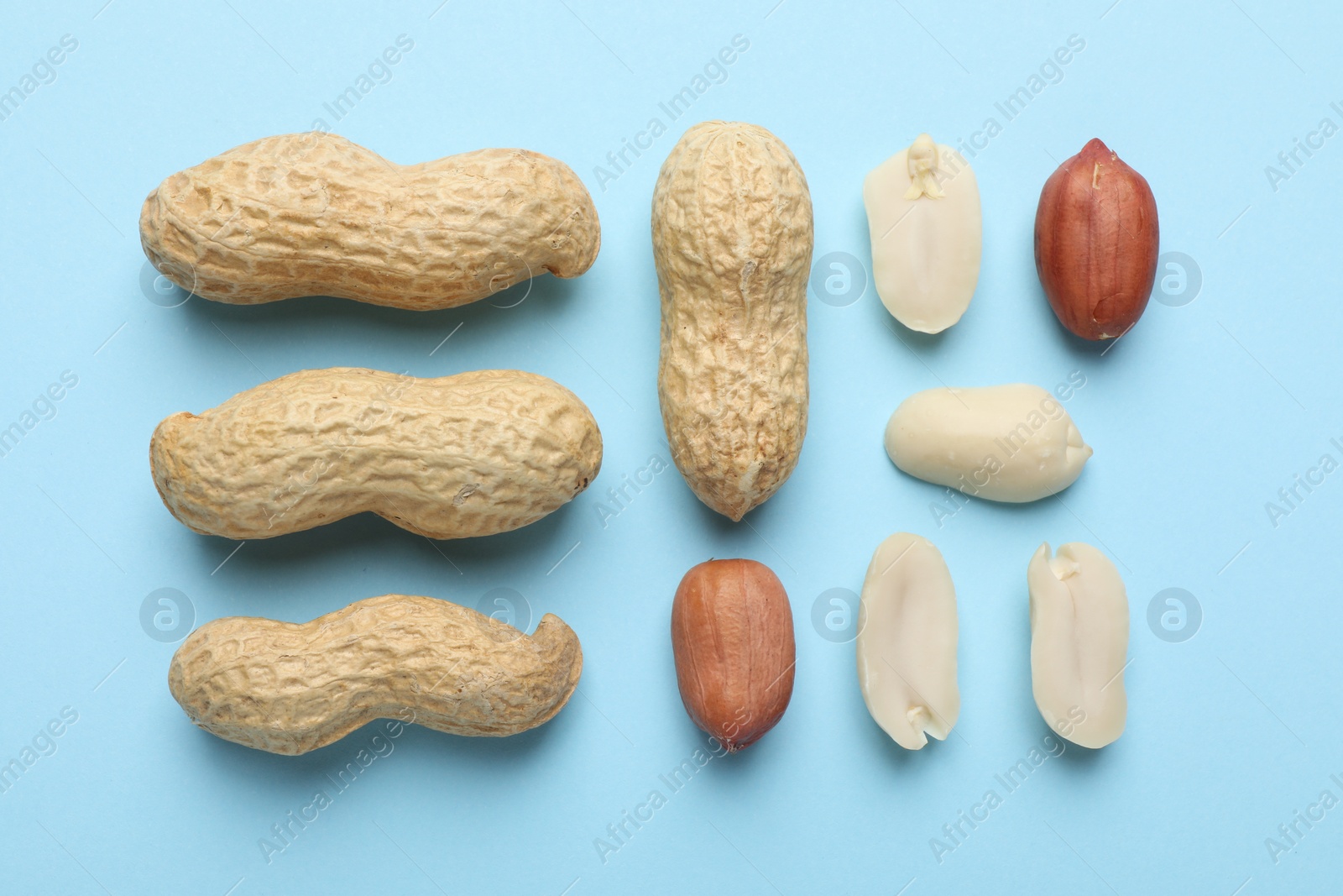 Photo of Fresh peanuts on light blue background, flat lay