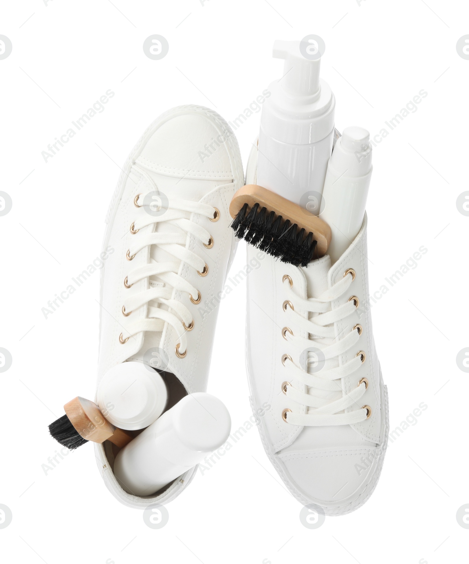 Photo of Stylish footwear with shoe care accessories on white background, top view