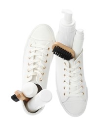 Stylish footwear with shoe care accessories on white background, top view