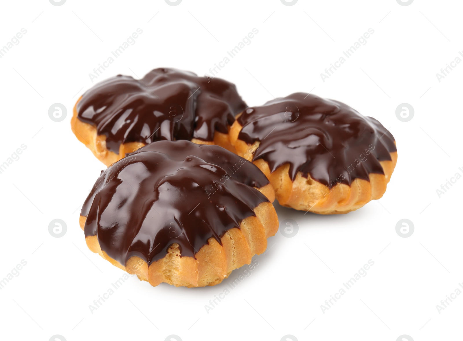 Photo of Delicious profiteroles with chocolate spread isolated on white