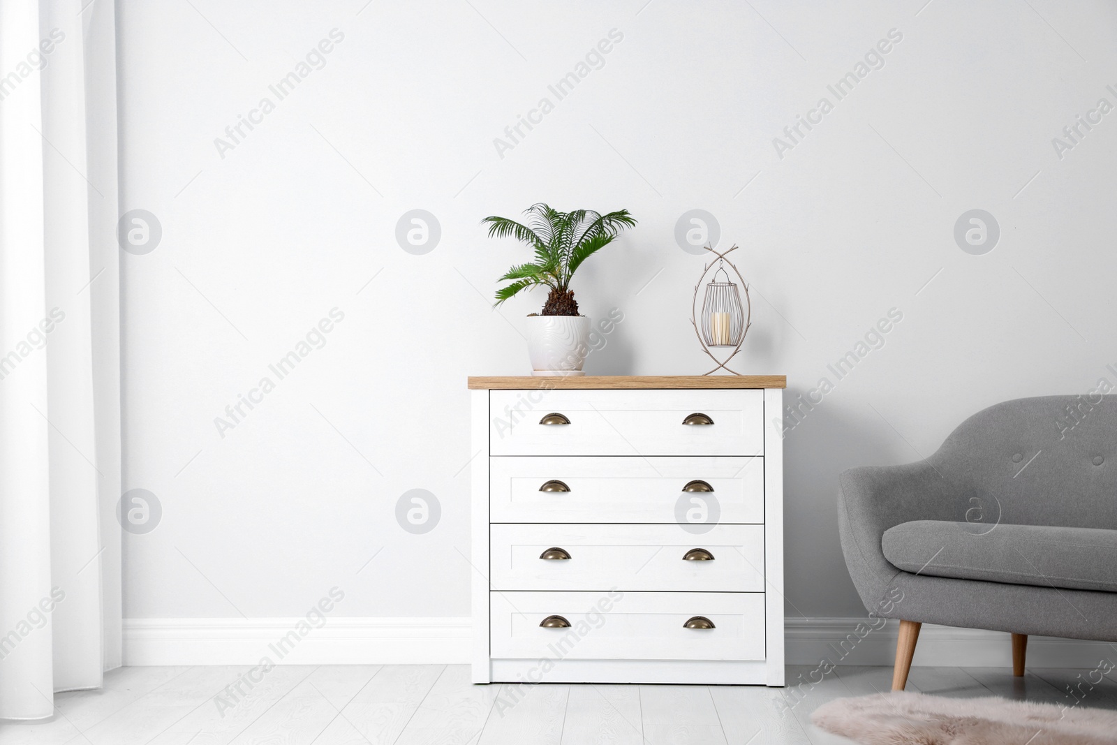 Photo of Chest of drawers in stylish living room interior