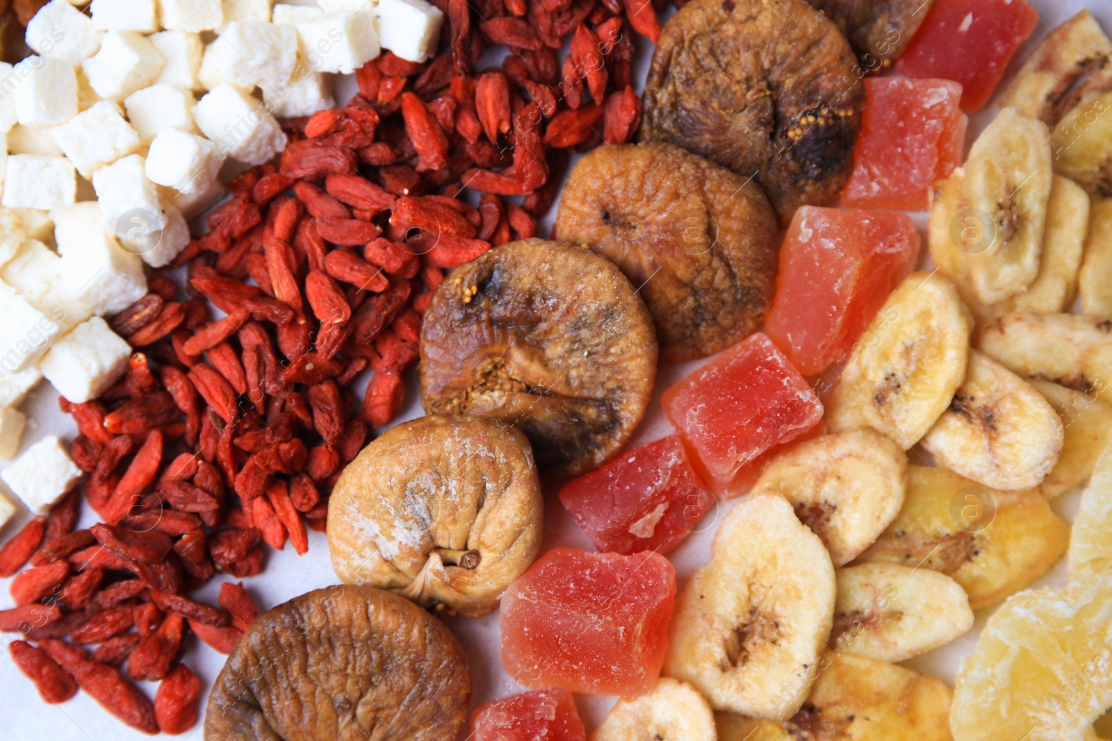 Photo of Different tasty dried fruits as background, top view